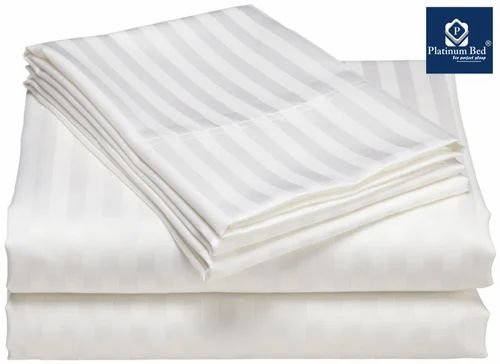 Folded white satin-stripe bed sheet set