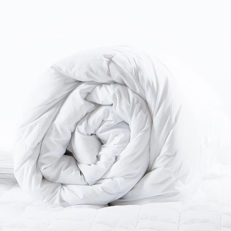 Rolled white quilted comforter