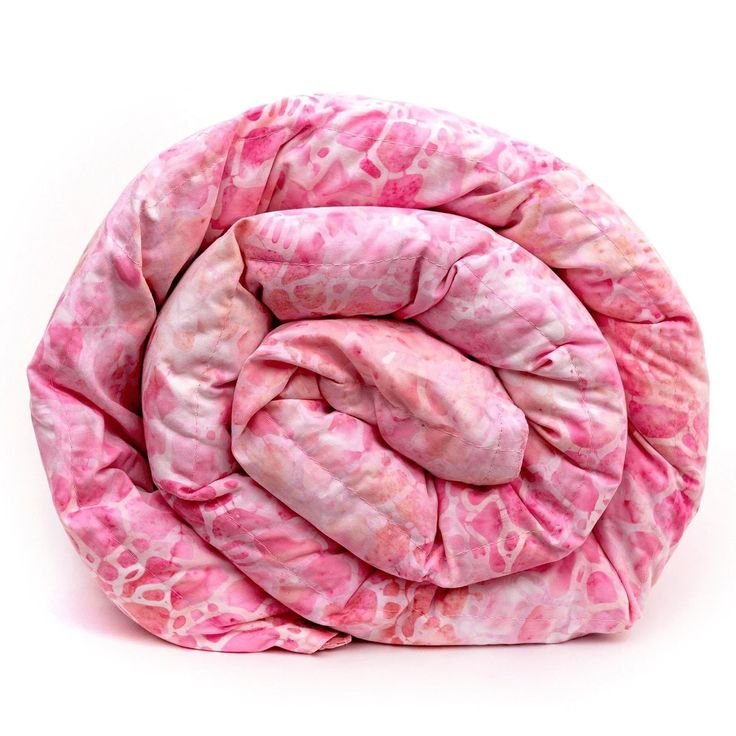 Rolled pink patterned quilt