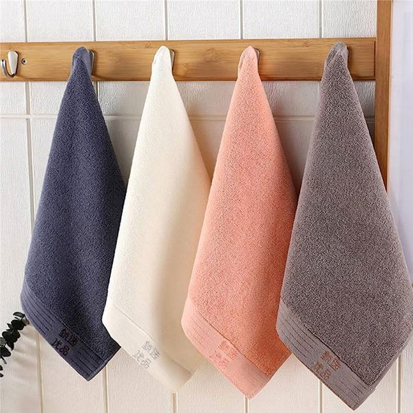 Designer cotton hand towels hanging in muted colours